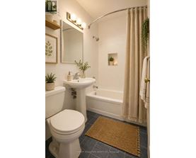 A bathroom with a white toilet, sink, and bathtub.