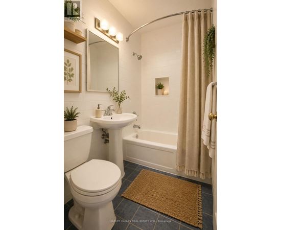 A bathroom with a white toilet, sink, and bathtub.