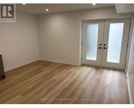 A room with a wooden floor and a white door.