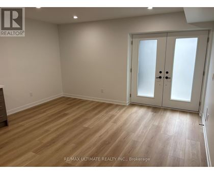 A room with a wooden floor and a white door.