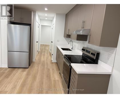 A kitchen with a refrigerator, stove, and oven.
