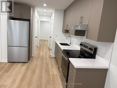 A kitchen with a refrigerator, stove, and oven.