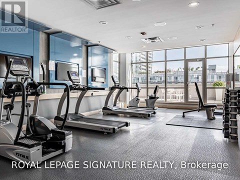 A gym with treadmills and a sign that says Royal LePage Signature Realty, Brokerage.