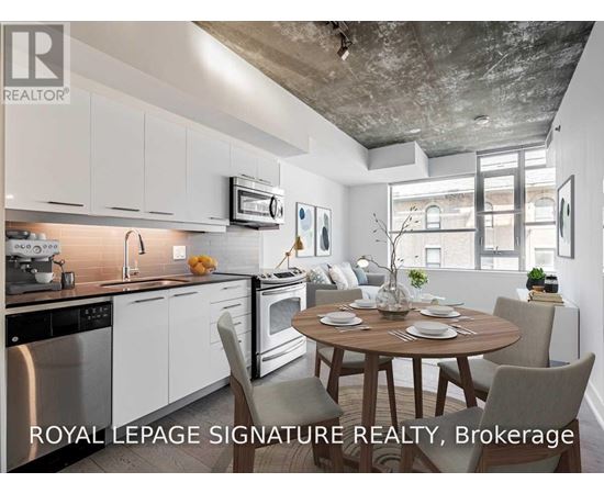 A modern kitchen with a dining table set for two.