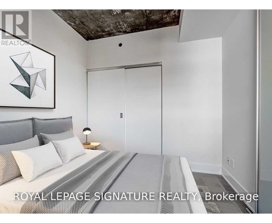 A bedroom with a bed, pillows, a lamp, and a painting on the wall.