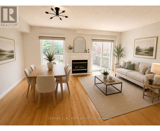 A living room with a fireplace and a dining table.