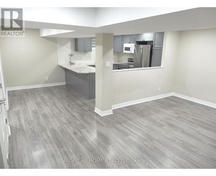 A kitchen area with a counter and cabinets.