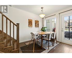 A dining room with a wooden table and chairs.