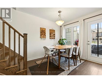 A dining room with a wooden table and chairs.