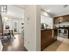 A kitchen with wooden cabinets and a stainless steel oven.