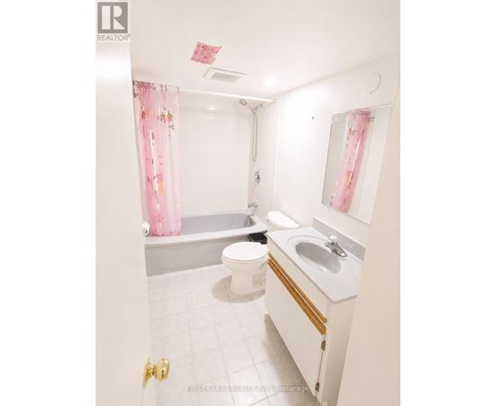 A white bathroom with a toilet, sink, and bathtub.