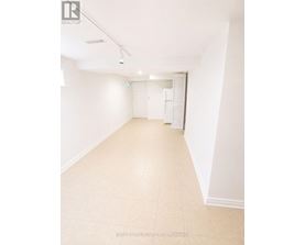 A white room with a tiled floor and a door on the right.