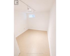 A room with a window and a tiled floor.