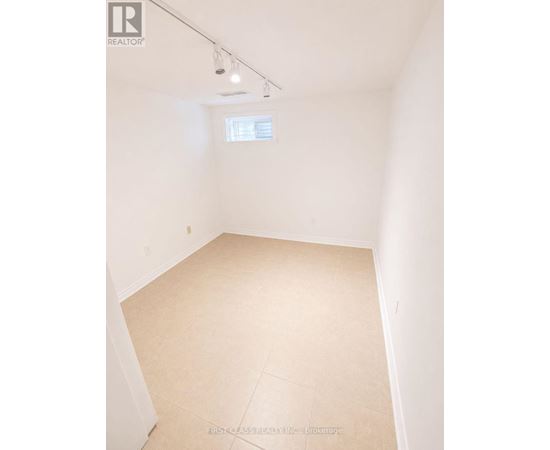 A room with a window and a tiled floor.