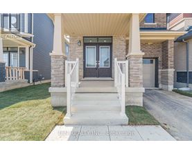 A house with a front porch and a sign that says "TEN REALTY INC. Brokerage".