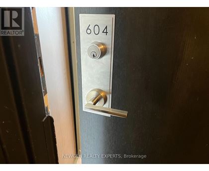 A door handle with the number 604 on it.