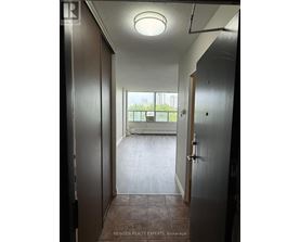 A hallway with a door on the left and another door on the right.