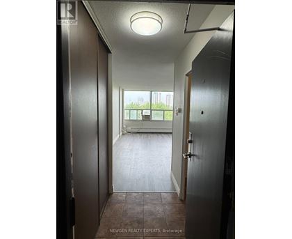 A hallway with a door on the left and another door on the right.