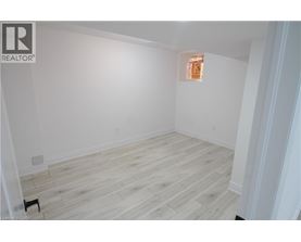 A room with wooden flooring and white walls.