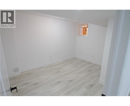 A room with wooden flooring and white walls.