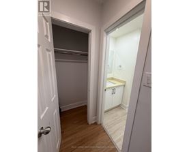 A white door is open to a small bathroom.