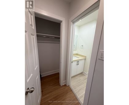 A white door is open to a small bathroom.