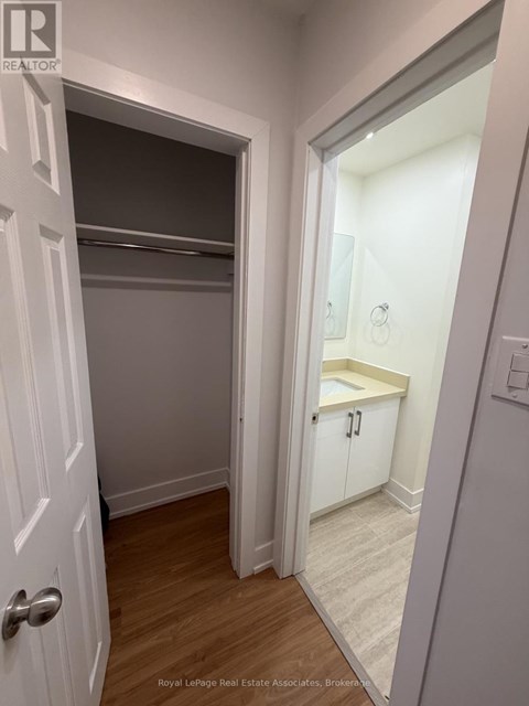 A white door is open to a small bathroom.