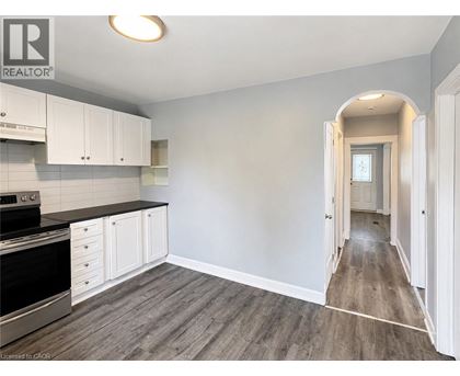 A kitchen with white cabinets and a black stove top oven.