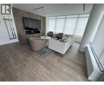 A living room with a television and a couch.