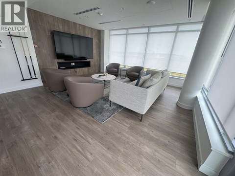 A living room with a television and a couch.