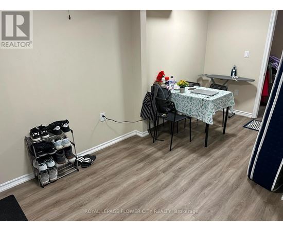 A room with a table and chairs and a rack of shoes.