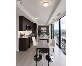 A modern kitchen with a dining table and chairs.