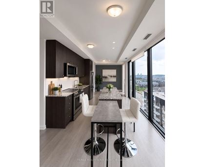 A modern kitchen with a dining table and chairs.