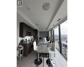 A modern kitchen with a dining table and chairs.