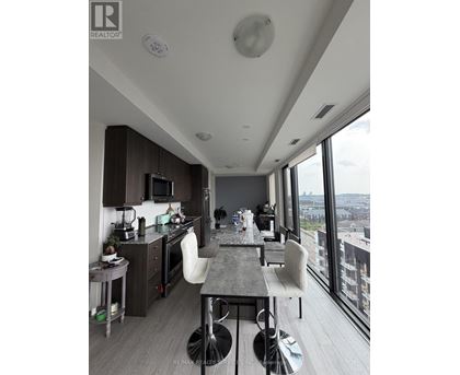 A modern kitchen with a dining table and chairs.