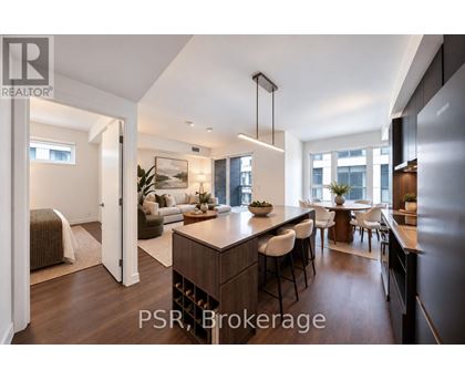A modern kitchen with a bar area and a dining table.
