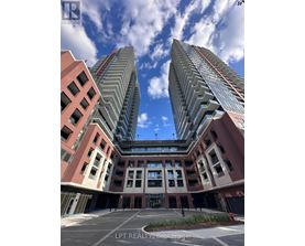 A modern building complex with a clear blue sky above.