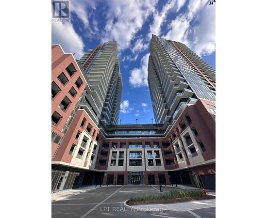 A modern building complex with a clear blue sky above.