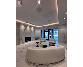 A reception area with a marble fireplace and a white circular table.