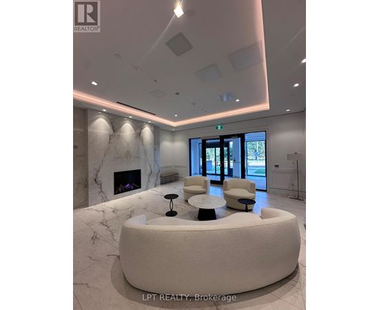 A reception area with a marble fireplace and a white circular table.