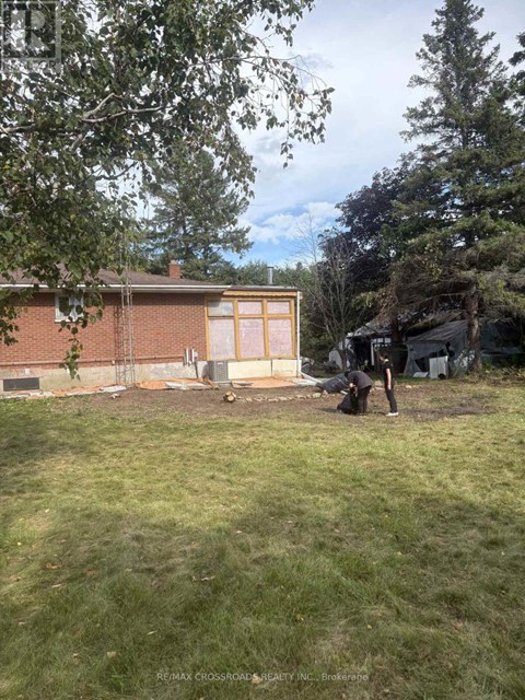 A person is working on a construction site in a backyard.