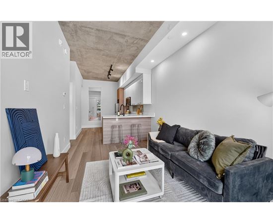 A modern living room with a grey couch and a white coffee table.