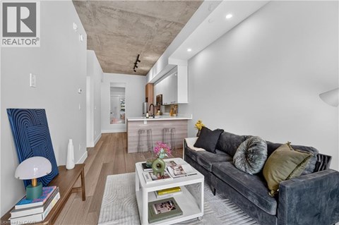 A modern living room with a grey couch and a white coffee table.