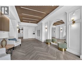 A spacious room with a herringbone patterned floor and white walls.