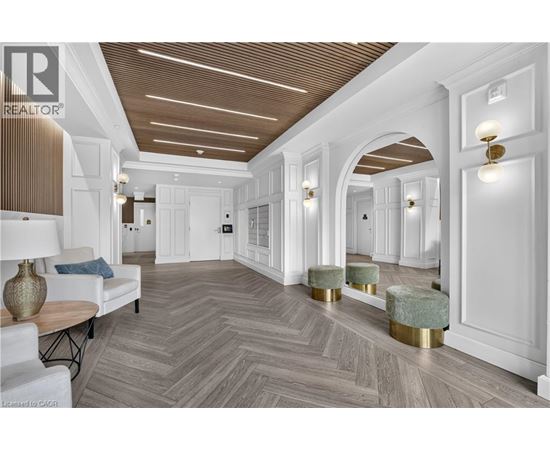 A spacious room with a herringbone patterned floor and white walls.