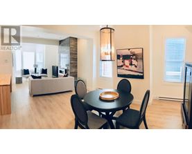 A dining room with a table set for four.