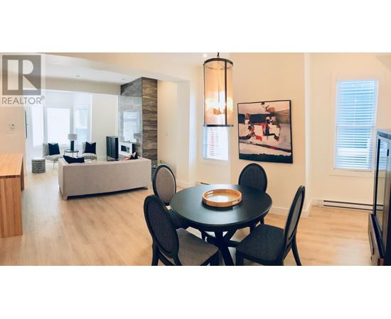 A dining room with a table set for four.