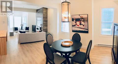 A dining room with a table set for four.