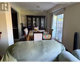 A dining room with a table set for four.