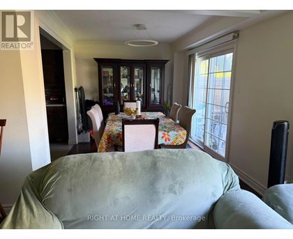 A dining room with a table set for four.